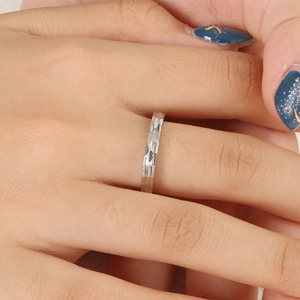 Minimalist silver hammer textured stainless steel ring shown on finger
