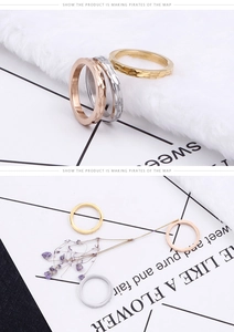 Detailed view of three minimalist hammered titanium steel rings in gold silver and rose gold
