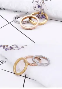 Detail of hammered texture on three-color minimalist titanium steel rings in gold and silver