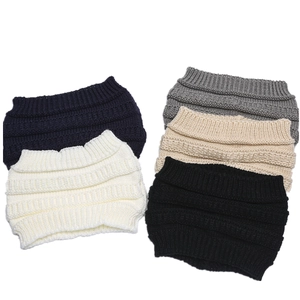 Flat lay detail of five chunky knit headbands in navy, white, grey, beige, and black colors