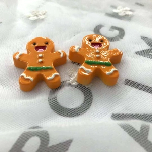 Close-up of orange gingerbread man resin charms for DIY hair accessories and crafts
