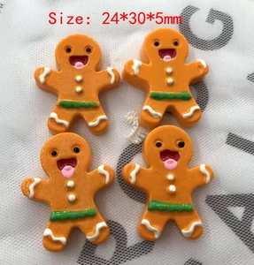 Detail view of 24x30x5mm orange gingerbread man resin charms for DIY hair accessories