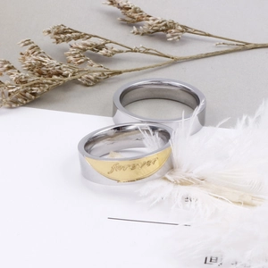 Polished titanium steel couple rings with Forever engraving and gold accent