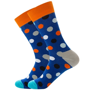 Détail de chaussettes mi-hautes en coton bleu marine avec pois colorés et bord côte