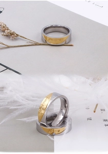 Detailed view of titanium steel rings with forever love engraving and small zircon stone