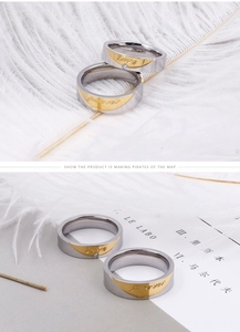 Detailed macro view of two-tone steel couple rings with Forever Love engraving and diamond