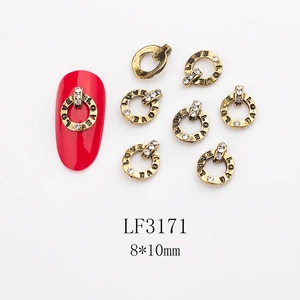 Detail of vintage gold LOVE charms with rhinestones for nail art, 8x10mm size
