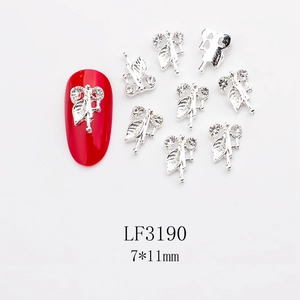 Close-up of 7x11mm silver leaf nail charms with rhinestones on a red manicure