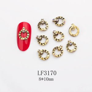 Close-up of retro gold nail charm with LOVE engraving and colorful rhinestone, 8x10mm size