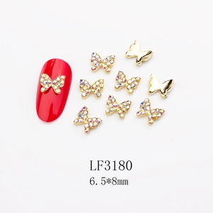 Macro shot of 6.5x8mm butterfly nail art charms with crystals and gold finish