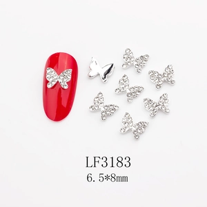 Detailed butterfly nail charm with rhinestones measuring 6.5x8mm on red nail art