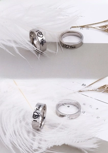 Detailed macro view of silver stainless steel rings with I Love You heart engraving