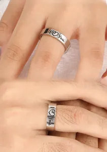 Macro detail of the silver polished stainless steel ring with I Love You heart engraving