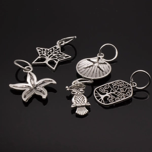 Detailed set of silver alloy charms featuring owl, starfish, shell and tree of life