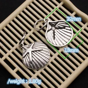 Detailed size view of silver vintage shell pendants with starfish motifs and dimensions