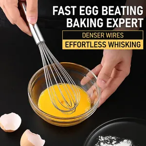 Manual stainless steel egg whisk with multi-wire head stirring egg wash in a glass bowl