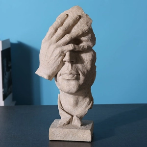 Nordic Silence is Gold resin sculpture of a face resting on a hand in beige finish