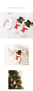 Detail of Christmas snowman gift tags with gold foil accents and festive ribbon bows