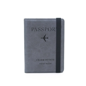 Slim dark grey RFID passport holder with elastic band closure for secure travel storage