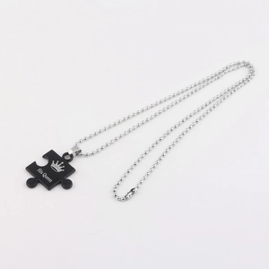 Detail of His Queen engraving on black puzzle pendant with silver bead chain