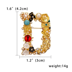 Close-up of D-shaped letter brooch with pearls, gems, and enamel flowers, 4.2x3.0cm