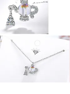 Detailed view of teapot pendant with iridescent crystal and pavé zircon stones