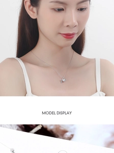 Detail view of aurora crystal teardrop necklace with silver crown and rhinestones