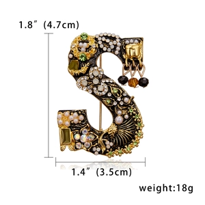 Detailed view of Letter S brooch with rhinestones and pearls including size and weight specs