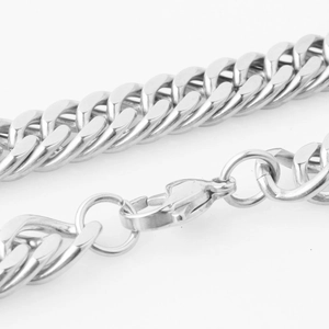 Detail of silver double-buckle curb chain with secure lobster clasp and metallic finish