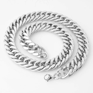 Detail view of silver curb chain with lobster clasp on a clean white background