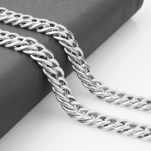 Close-up of a silver Cuban link chain necklace showing polished metal texture and links