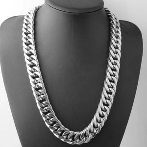 Classic silver Cuban link chain necklace for men displayed on a professional black bust