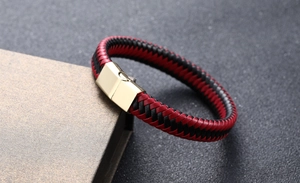 Detail of red and black woven leather bracelet with a polished gold magnetic metal clasp