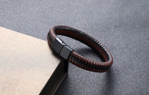 Detail of hand-woven leather rope bracelet with black magnetic buckle on a gift box
