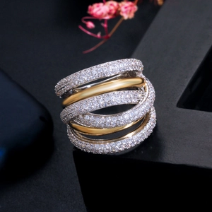 Macro shot of two-tone layered pavé ring with gold and silver bands on black base
