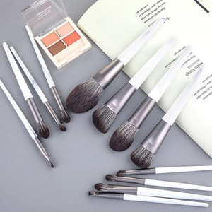 Detail of 12-piece makeup brush set with white handles and gradient grey synthetic bristles