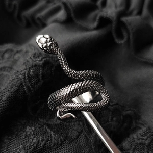 Vintage gothic snake wrap ring in dark silver metal on elegant black lace background