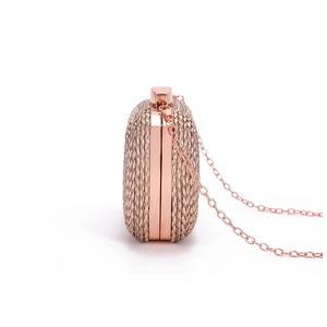 Detail view of the rose gold woven evening bag side structure with metal chain strap