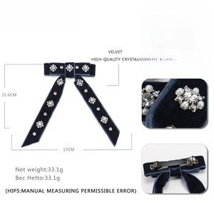 Navy velvet bow hair clip with crystal floral accents and pearls on white background