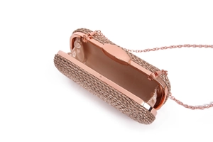 Detail of rose gold woven clutch bag showing the inner structure and metal chain strap