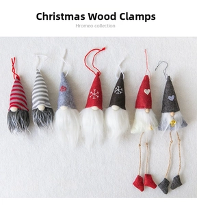 Detail of seven Nordic wool felt Christmas gnomes with wooden clips on white background