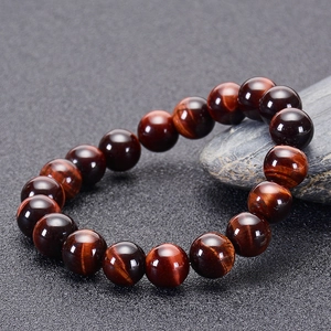 Macro detail of natural red tiger eye stone bracelet with polished 10mm round beads
