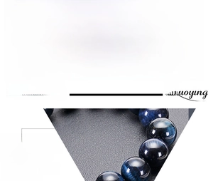 Macro detail of natural dark blue tiger eye beads showing chatoyant light reflection