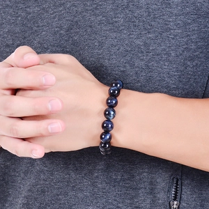 Natural deep blue tiger eye stone bracelet with 10-12mm round beads on person wrist