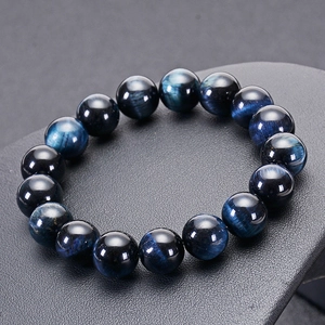Natural dark blue tiger eye stone bracelet with cat eye effect on jewelry display