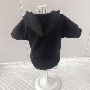Detail of black pet hoodie with pocket and hood on model for small dogs and cats