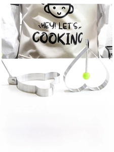Close-up of heart and bear shaped stainless steel egg rings with green handle grips