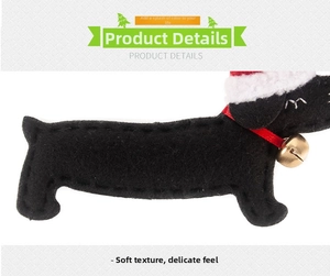 Detailed view of handmade felt dachshund Christmas ornament with Santa hat and gold bell