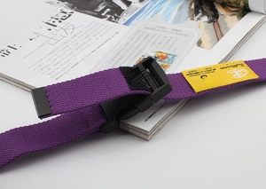 Detail of purple nylon canvas belt with black plastic buckle and yellow size S label