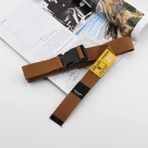 Detail of brown canvas tactical belt featuring a plastic buckle and star patch detail